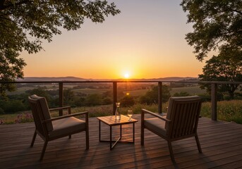 Obraz premium Chairs and table on deck overlooking landscape at sunset