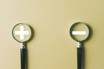 Two magnifying glasses focusing on plus and minus symbols. Concept for analyzing pros and cons,detailed comparison,strategic analysis,decision-making, strategic choice.