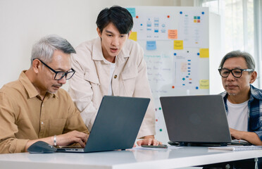 Asian Instructor Teaching Senior in Software Programming and Training Collaboration