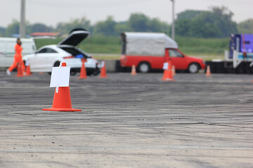 Traffic cone on the race track with tire tracks.