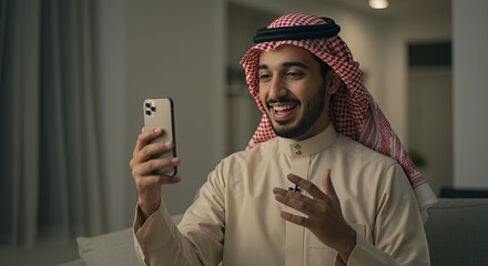 Smiling Arabian man video calling on smartphone