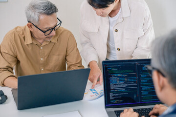 Group of asian senior in a collaborative software development analyzing  flowcharts  during a bootcamp training