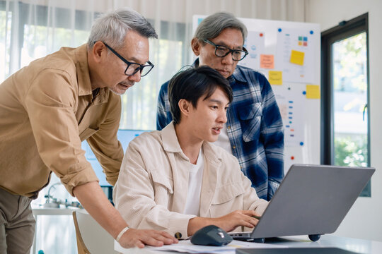 Group of asian senior in a collaborative software development analyzing  flowcharts  during a bootcamp training - Powered by Adobe
