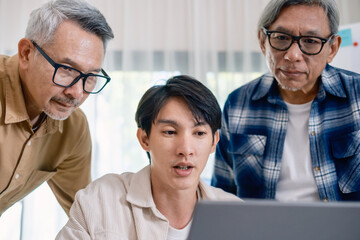 Group of asian senior in a collaborative software development analyzing  flowcharts  during a bootcamp training