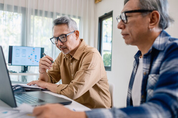 Senior male participating in a computer programming bootcamp, improving skills and learning coding and develope collaborating in brainstorming and coding project
