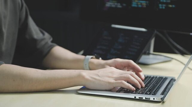 Young adult Asian female software developer coding program on desktop computer. Woman work from home, remote working, freelance programmer job, smart digital nomad lifestyle concept. Close Up