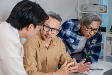 Team of developers collaborating in brainstorming and coding project at office workspace
