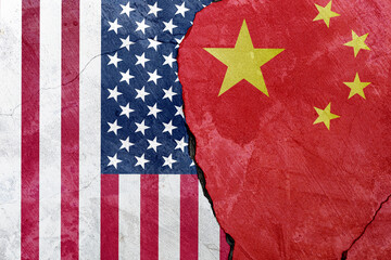 Flags of the United States and China on cement background. Concept of trade war between United...