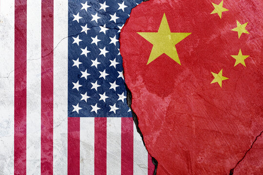 Flags of the United States and China on cement background. Concept of trade war between United States and China, negotiations of superpowers, trade competition, tariff changes affecting world economy. - Powered by Adobe
