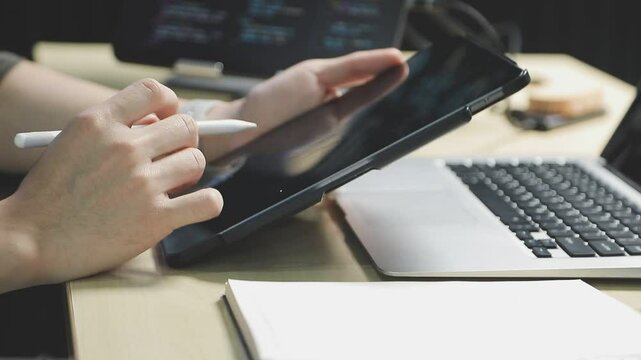 Young adult Asian female software developer coding program on desktop computer. Woman work from home, remote working, freelance programmer job, smart digital nomad lifestyle concept. Close Up