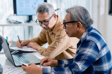 Senior male participating in a computer programming bootcamp, improving skills and learning coding and develope collaborating in brainstorming and coding project