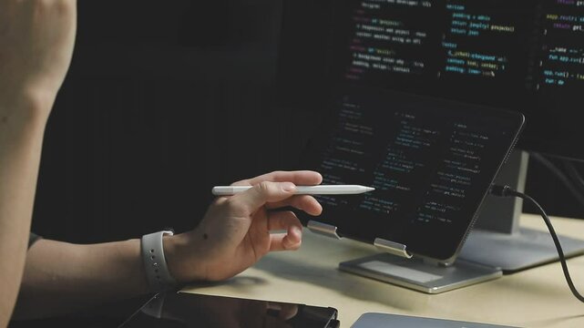 Young adult Asian female software developer coding program on desktop computer. Woman work from home, remote working, freelance programmer job, smart digital nomad lifestyle concept. Close Up
