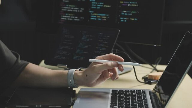 Young adult Asian female software developer coding program on desktop computer. Woman work from home, remote working, freelance programmer job, smart digital nomad lifestyle concept. Close Up