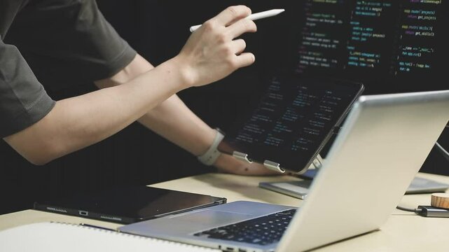 Young adult Asian female software developer coding program on desktop computer. Woman work from home, remote working, freelance programmer job, smart digital nomad lifestyle concept. Close Up