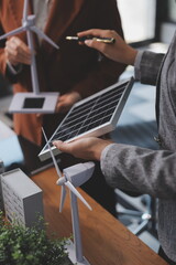 Discussion among businesspeople on the latest developments in solar cell panel technology and Solar Energy Environment city Concept.