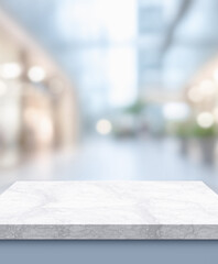 Empty marble platform with a soft-focused modern mall background, ideal for product presentation, retail advertising, or commercial mockups..
