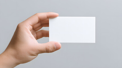 Obraz premium Hand Holding a Blank Business Card Mockup isolated On White