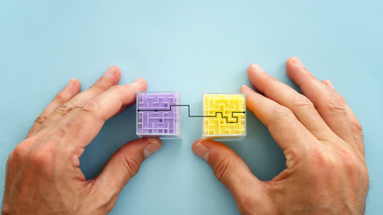 Hand holding cubes with maze pattern. Concept of challenge and problem solving