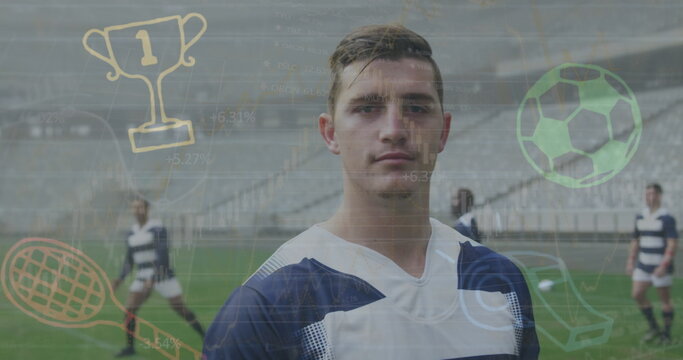 Standing soccer player wearing navy-striped uniform on stadium pitch, with digital sports icons - Powered by Adobe