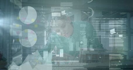 Image of various digital data moving over focused caucasian businesswoman working in office
