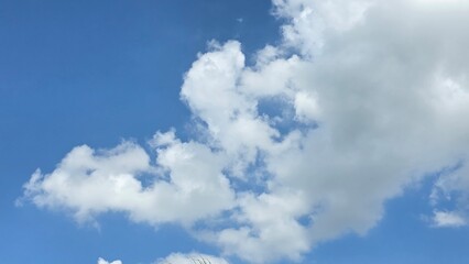 Blue sky with scattered fluffy white clouds