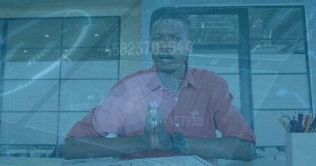 Image of financial data processing over african american businessman on image call
