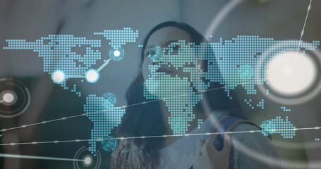 Image of network of connections with world map over woman in city