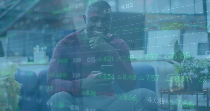 Image of financial data processing over african american businessman using smartphone