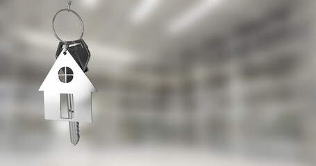 Image of silver house keys hanging against blurred background with copy space
