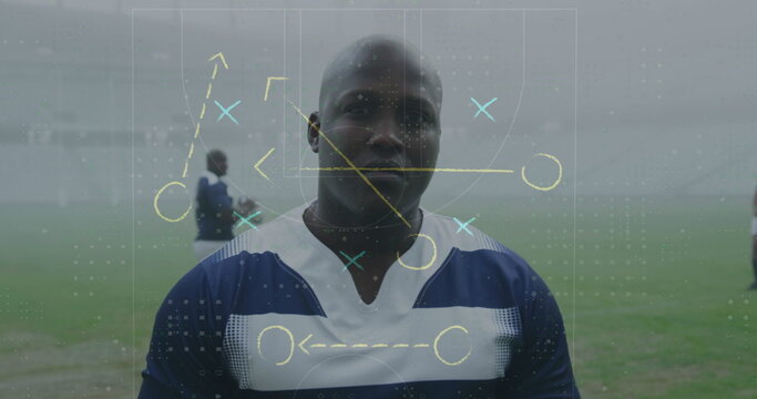 Standing rugby player wearing jersey on grassy pitch with white lines digital tactical overlay