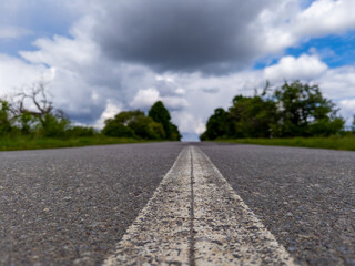 A long empty road with a white line on the side of it