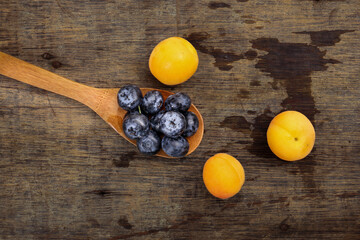 Fresh ripe whole blueberries apricot on rustic wood background wooden spoon blue berry
