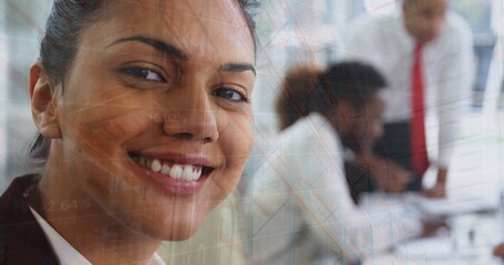 Image of graphs over diverse businesspeople working in office
