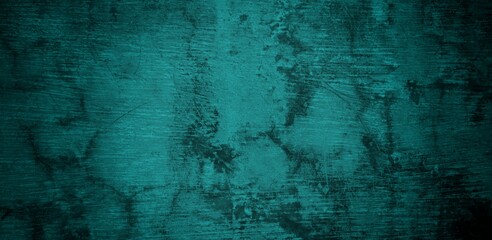  A textured background featuring a deep teal color with a distressed, grunge appearance. The surface shows variations in tone and subtle patterns, creating an abstract and moody aesthetic.