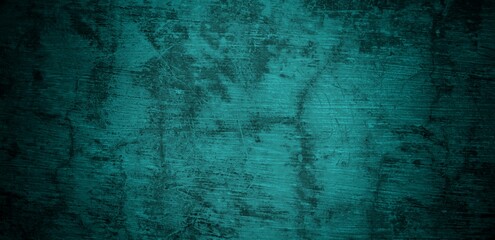 Obraz premium A textured background featuring a deep teal color with a distressed, grunge appearance. The surface shows variations in tone and subtle patterns, creating an abstract and moody aesthetic.