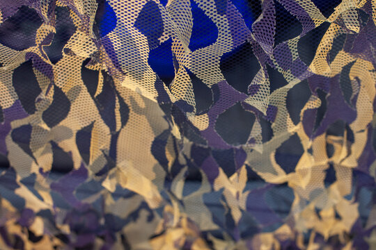 Detailed view of modern camouflage netting for hunting, featuring an advanced Optifade Timber pattern