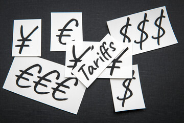 Dollar, euro and yen currency symbols, tariffs.