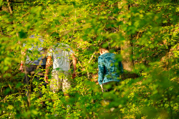 Father with his sons are walking on a hiking trail