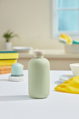 On a minimalist kitchen background with many tools for cleaning the kitchen, a green product bottle without label is placed in the center, no label for branding design, kitchen cleaning products