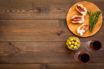 Antipasti - prosciutto ham and glass of wine. Traditional Spanish meal