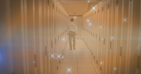 Image of moving stars and caucasian male worker over server room