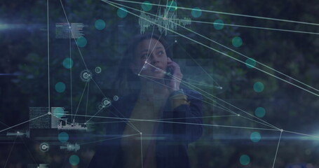 Image of network of connections over african american businesswoman talking on smartphone