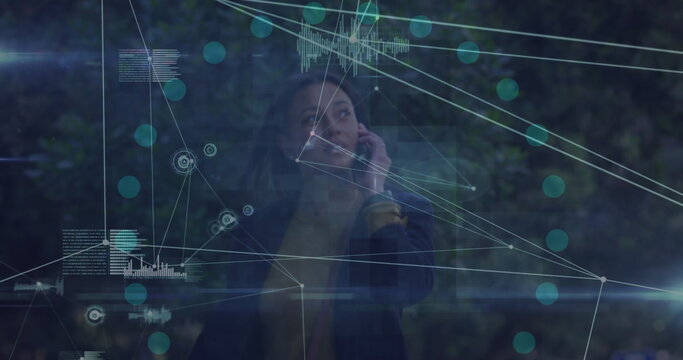 Image of network of connections over african american businesswoman talking on smartphone