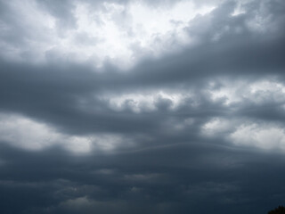 Obraz premium Dark, dramatic, oddly shaped clouds in the sky before a strong thunderstorm, bad weather, rain