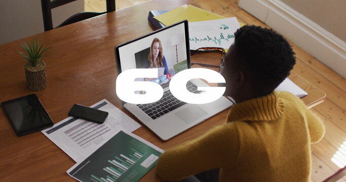 Image of 6g text banner over african american woman having a image call on laptop at home - Powered by Adobe