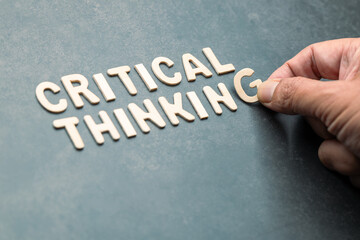 CRITICAL THINKING wooden letters, symbolizing thought process and intellectual development