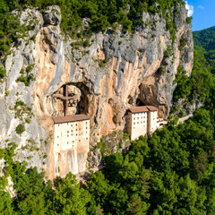 Aerial View of Monastery Built into Dramatic Cliffside Caves Stunning Landscape