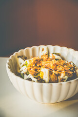 Burnt Brussels Sprouts with Char, Cream, and Umami Honey miso glaze, sour cream, fried shallots, chives
