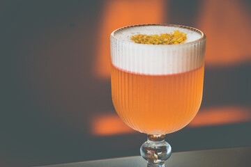 A Coconut Campari cocktail made with
Campari, gin, coconut, lemon