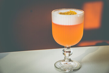 A Coconut Campari cocktail made with.Campari, gin, coconut, lemon